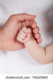 Baby and man hand.