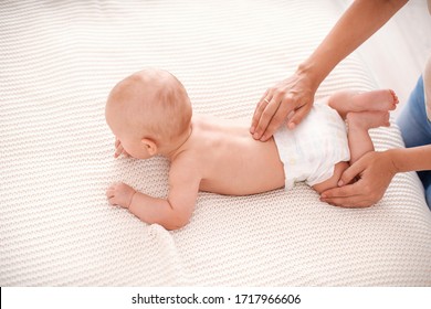 Baby Massage. The Baby Is 5 Months Old, Lying On His Tummy And Trying To Crawl. Mother Gives Back Massage To The Child, For Its Development. Children's Gymnastics And Exercises.