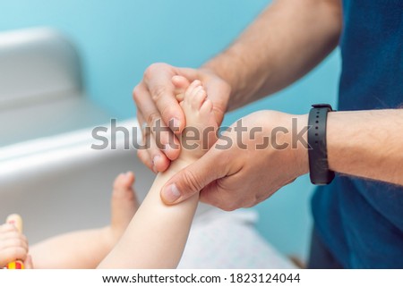 Baby massage closeup. Father and child. Newborn.