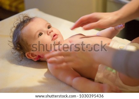 Baby massage. Massagist making massage to a small baby