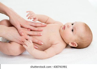 Baby Massage. Mom Massaging Kid Belly. Treatment Of Colic