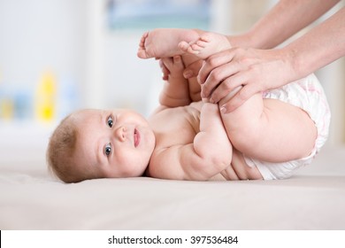 Baby massage. Mother doing gymnastics kid.