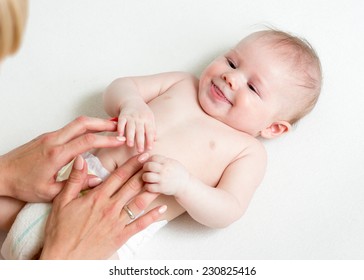 Baby Massage. Mother Massaging Infant Belly, Kid Laughing