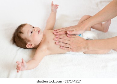 Baby Massage. Mother Massaging Infant Belly, Kid Smiling