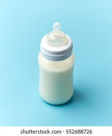 Baby Milk Bottle On Blue Background