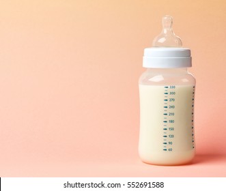 Baby Milk Bottle On Pink Background