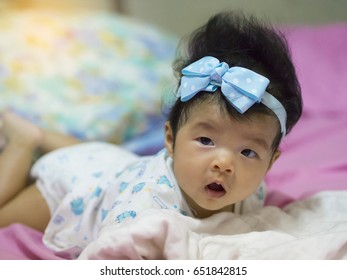 Baby In Moment Turn Up Side Down On Bed 4 Month Old, Baby Development And Learning Concept