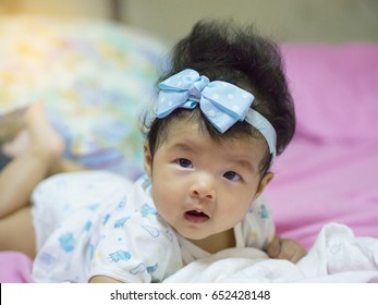 A Baby In Moment Turn Up Side Down On Bed 4 Month Old, Baby Development And Learning Concept ,Soft Focus Background