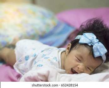 A Baby In Moment Turn Up Side Down On Bed 4 Month Old, Baby Development And Learning Concept ,Soft Focus Background