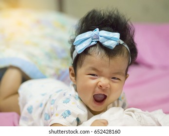 A Baby In Moment Turn Up Side Down On Bed 4 Month Old, Baby Development And Learning Concept ,Soft Focus Background