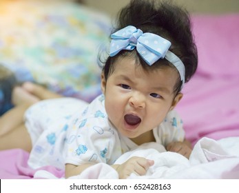 A Baby In Moment Turn Up Side Down On Bed 4 Month Old, Baby Development And Learning Concept ,Soft Focus Background