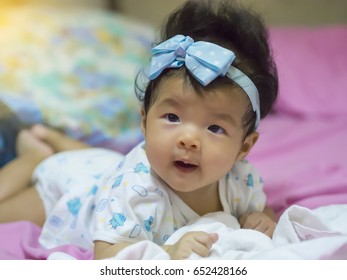 A Baby In Moment Turn Up Side Down On Bed 4 Month Old, Baby Development And Learning Concept ,Soft Focus Background