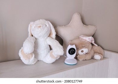 Baby Monitor Camera Between Stuffed Animals And Toys