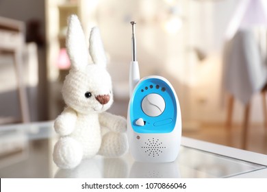 Baby monitor and toy on table in room. Radio nanny