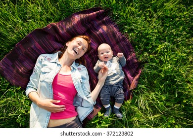 Baby And Mother On Nature In The Park
