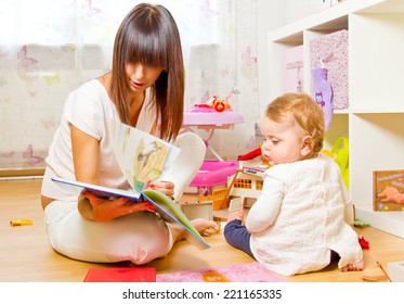 Baby And Mother With Picture Book