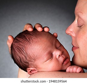 Baby In Mother's Arms Been Cared For After Having A Good Sleep In Bed Stock Photo