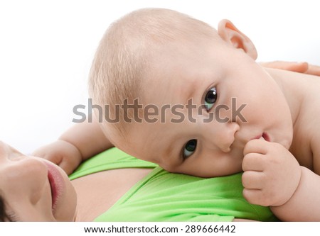 baby is in its mother's breast and sucks her finger
