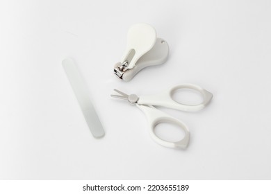 Baby Nail Care Devices On A White Background: Scissors, Nail File, Nail Clipper. Child Hygiene Items