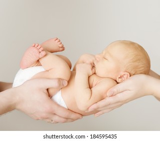 Baby Newborn Sleeping On Parents Hands, New Born Kid Sleep In Family Hand, Child Mother Father Over Gray Background