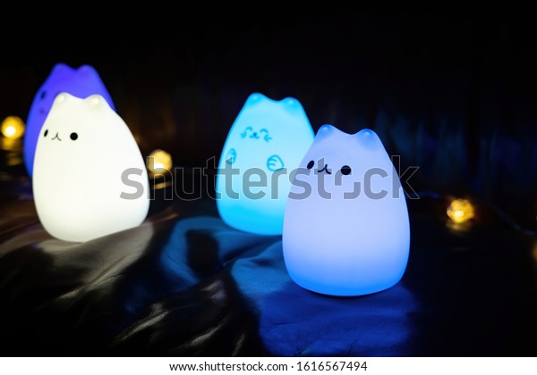 Baby night lamp, five nightlights in a row,\
different colors. Children\'s night lights. Night shooting. Several\
lamps on the couch.