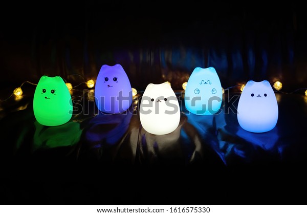 Baby night lamp, five nightlights in a row,\
different colors. Children\'s night lights. Night shooting. Several\
lamps on the couch.