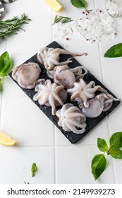 Baby Octopus. Freshly Frozen. Beautiful Serving On A Platter. With Herbs And Spices On A Light Background