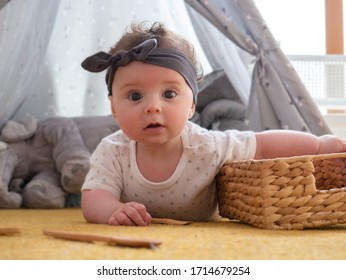 Baby On The Floor Learning To Pick Up Objects, Montessori Method