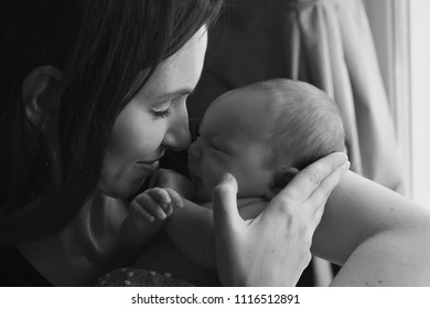 baby on the hands of mother on a white and black colours