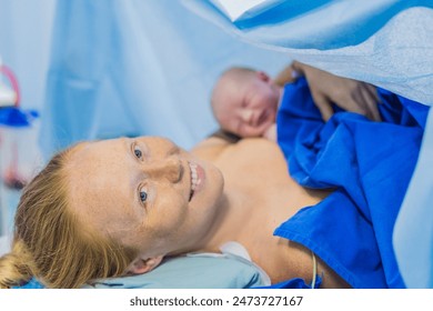 Baby on mother's chest immediately after birth in a hospital. The mother and newborn share a tender moment, emphasizing the bond and emotional connection. The medical staff ensures a safe and caring - Powered by Shutterstock