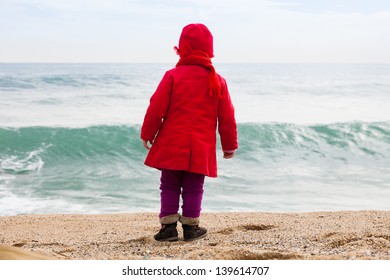 Baby  On Sand Beach In Cold Windy Day