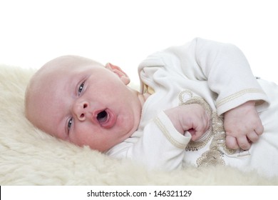 Baby on a sheepskin. Baby is three month old. Studiolight with white background