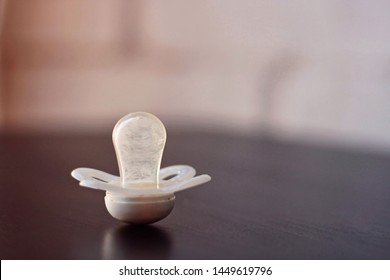 Baby pacifier on a black and white background.

