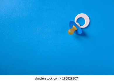 Baby Pacifier On A Blue Background, Top View, Place For An Inscription