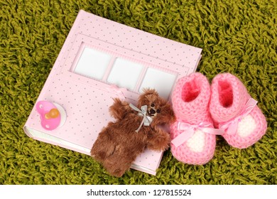 Baby Photo Album On Green Carpet