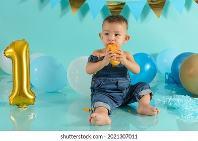 Baby In Photo Session Eating Mango. Baby Photo Session.