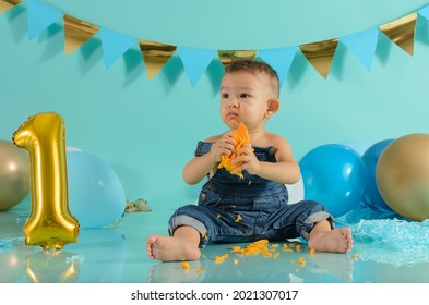 Baby In Photo Session Eating Mango. Baby Photo Session.