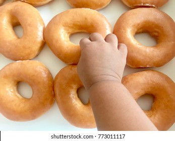 Baby Picking Sugar Glazed Donuts