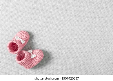 Baby Pink Shoes For Newborn Girl On Knitted Gray Plaid. Flat Lay, Top View, Copy Space