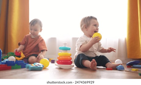 baby play with toys on floor in kindergarten. happy family kid dream kindergarten concept. baby toddler boy playing with toys indoors sitting on lifestyle the floor - Powered by Shutterstock