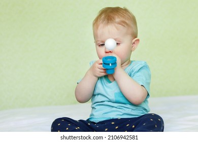 A Baby Is Playing With An Airball At Home. Children's Play Center For Early Development. Copy Space - The Concept Of Breathing Exercises, The Correction Of Speech Defects, Speech Therapy, Skills