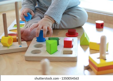 baby playing with colorful wooden blocks