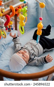 Baby Playing In A Crib