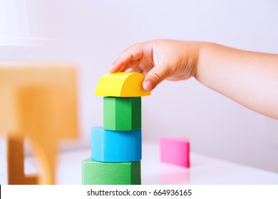 Baby Playing And Discovery With Colorful Toys At Home, Close-up Detail. Toddler Plays With Toy Blocks And Constructors. Early Development, Learning And Education Of Child Or Baby - Background Concept.