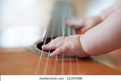 Baby playing the guitar