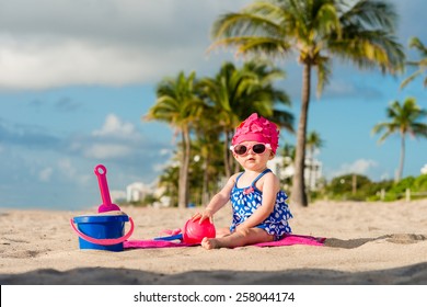 Baby Playing On Beach
