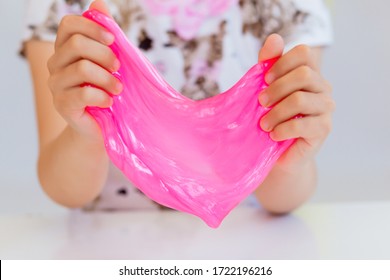 Baby Playing Slime At Home. Black And Pink Slime