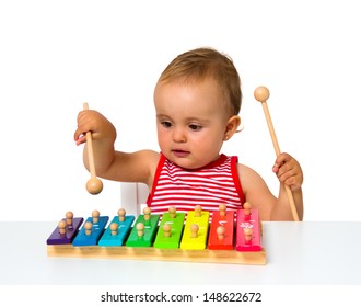 baby playing xylophone isolated on white