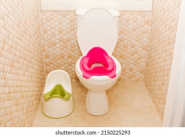 Baby Potty And Baby Pink Toilet Seat. Hygiene. Children's Toilet. Children's Pad, Cover. The Child Goes To An Adult Toilet.