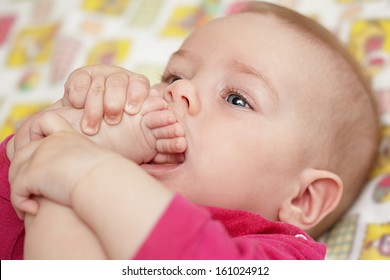 The Baby Pulls A Foot In A Mouth